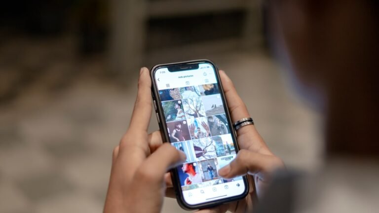 a person holding a cell phone in their hand