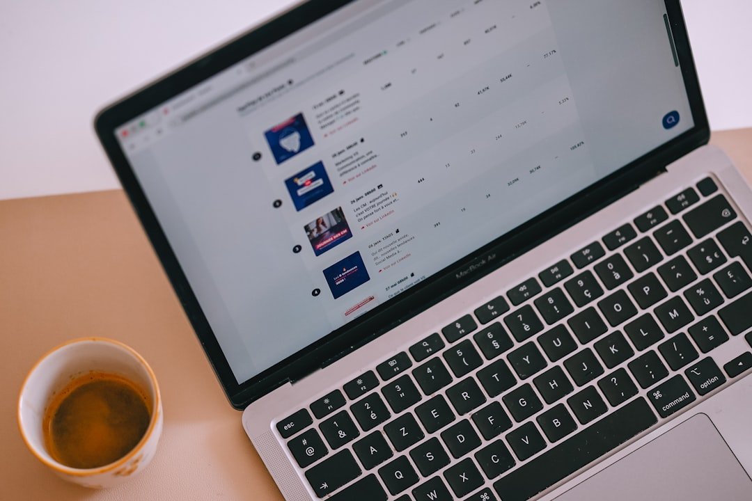 Laptop with content on screen and a cup of coffee