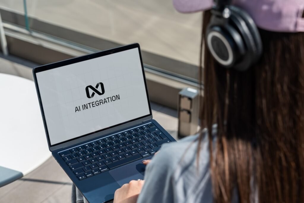 Person using laptop with ai integration logo displayed