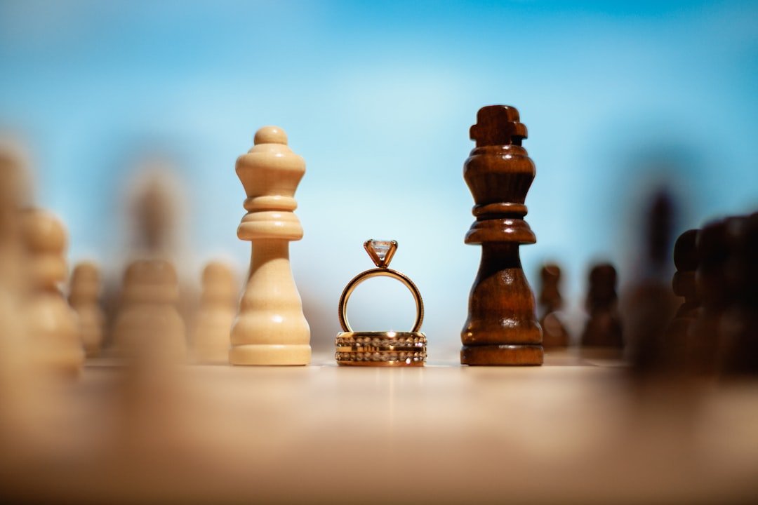 Two chess kings and wedding rings on a chessboard
